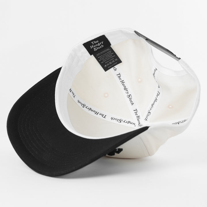Black and white cap with 'The Hungry Sloth' branding