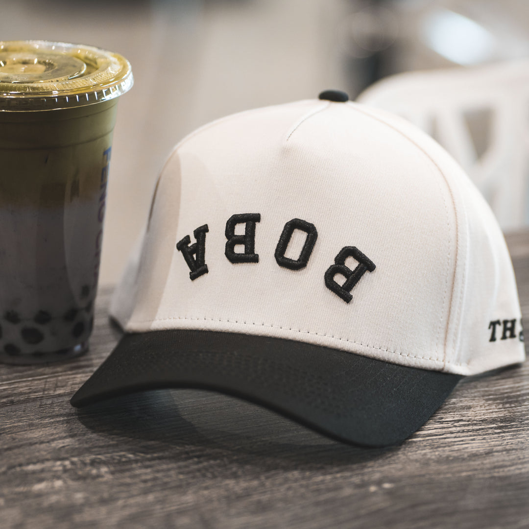 boba upside down hat with boba milk tea next to it