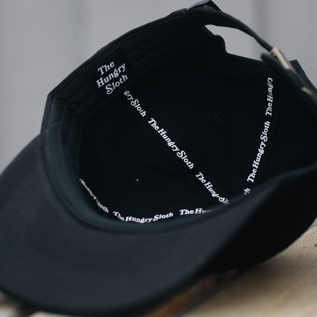the hungry sloth dad hat in black