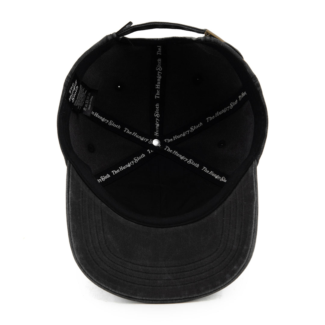 vintage black dad hat with the hungry sloth branding underneath