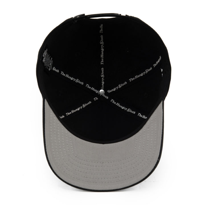 black snapback hat with grey undervisor and the hungry sloth branding underneath