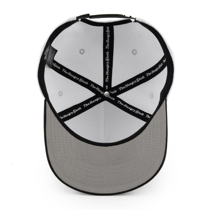 white snapback hat with grey undervisor and the hungry sloth branding underneath