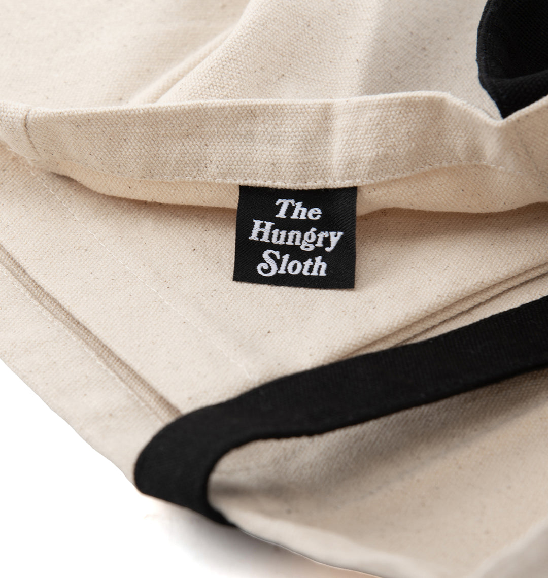 the hungry sloth tote bag