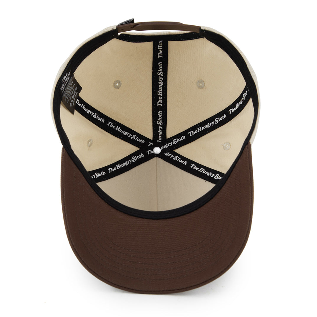 natural and brown snapback hat with the hungry sloth branding underneath
