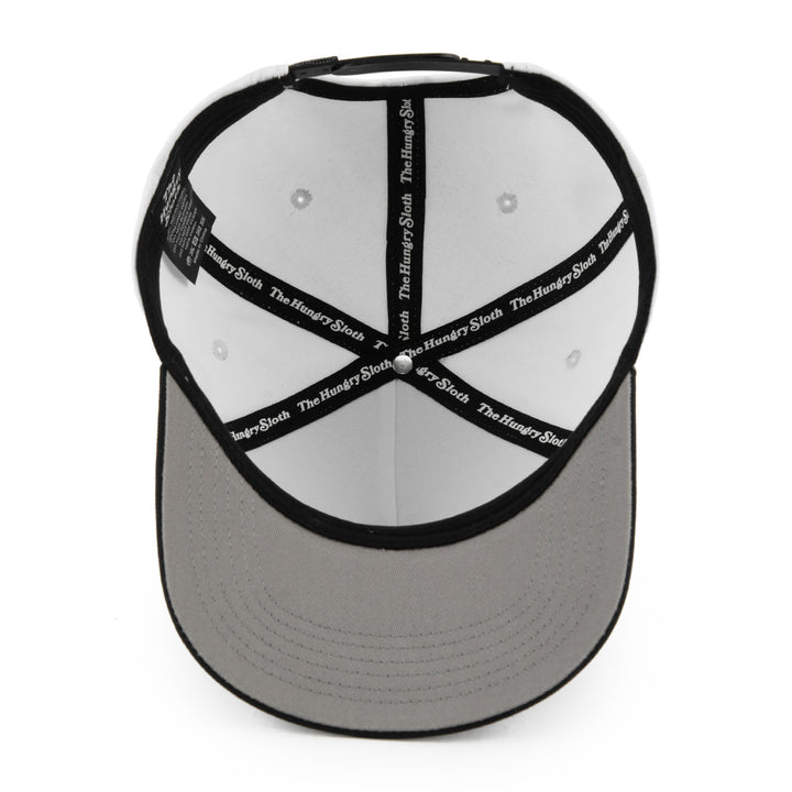 white and black snapback hat from the bottom angle with the hungry sloth branding and a grey undervisor