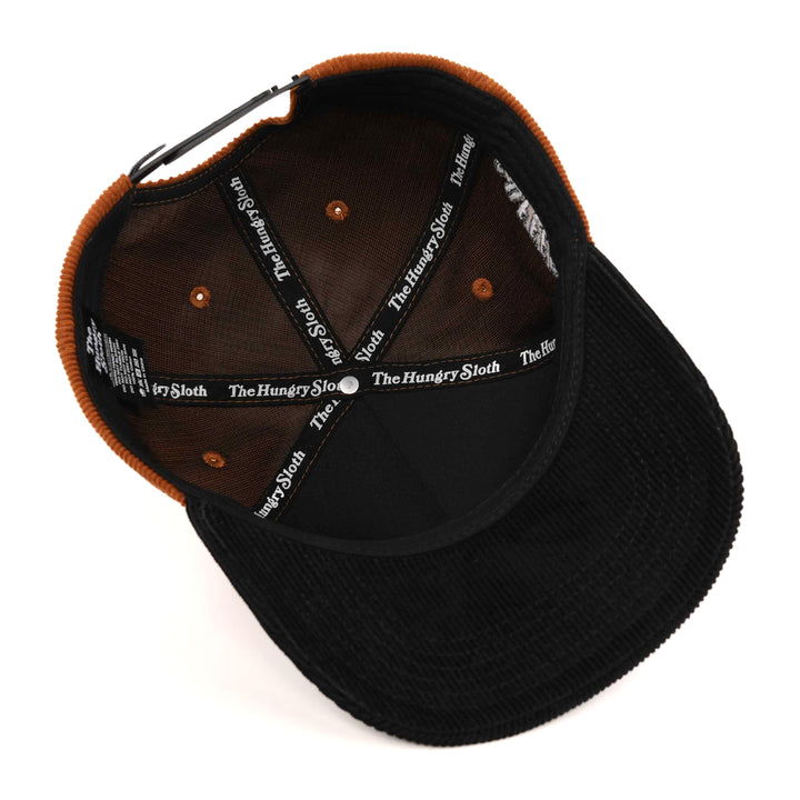 light brown and black corduroy snapback hat with the hungry sloth branding underneath