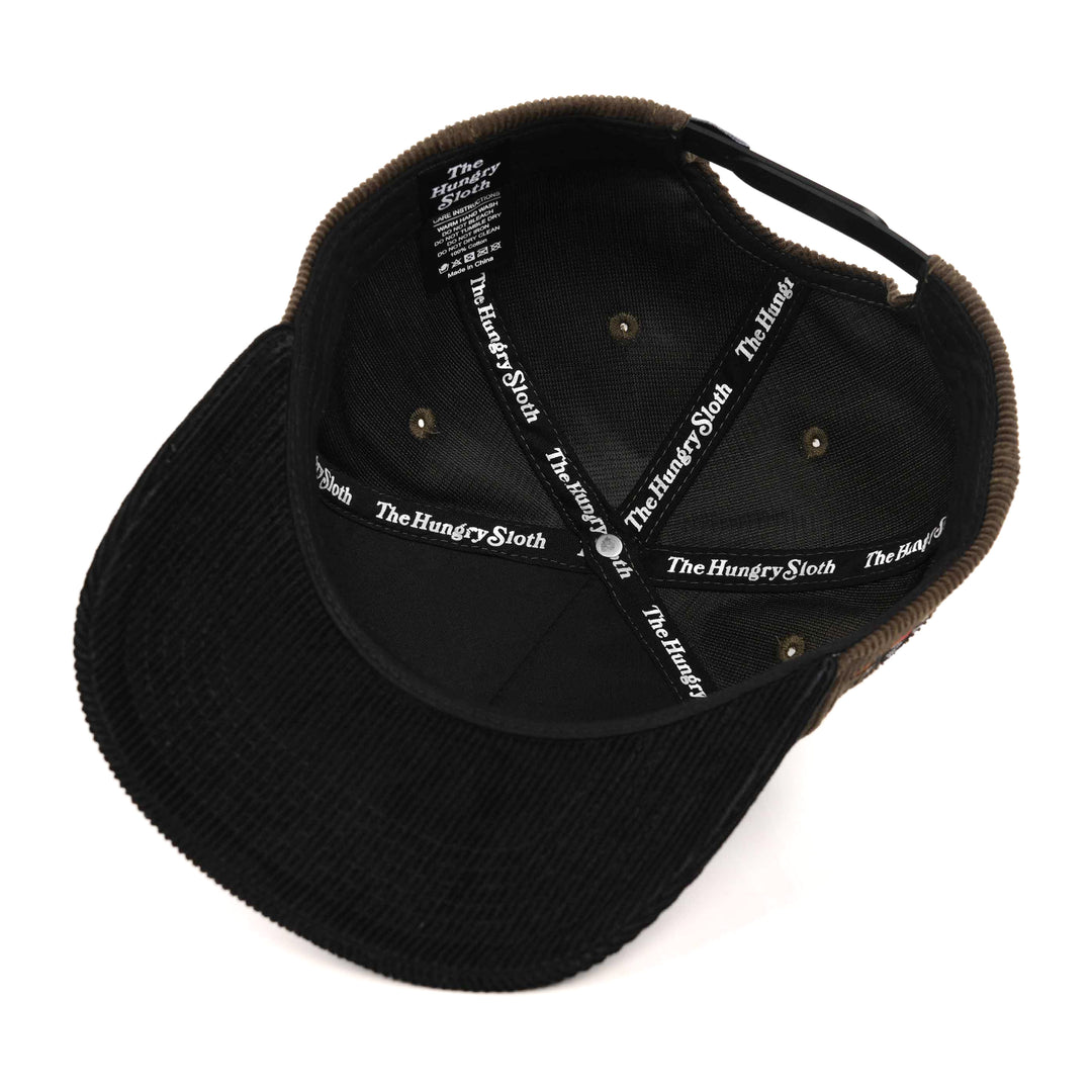 brown and black corduroy snapback hat from underneath with the hungry sloth branding