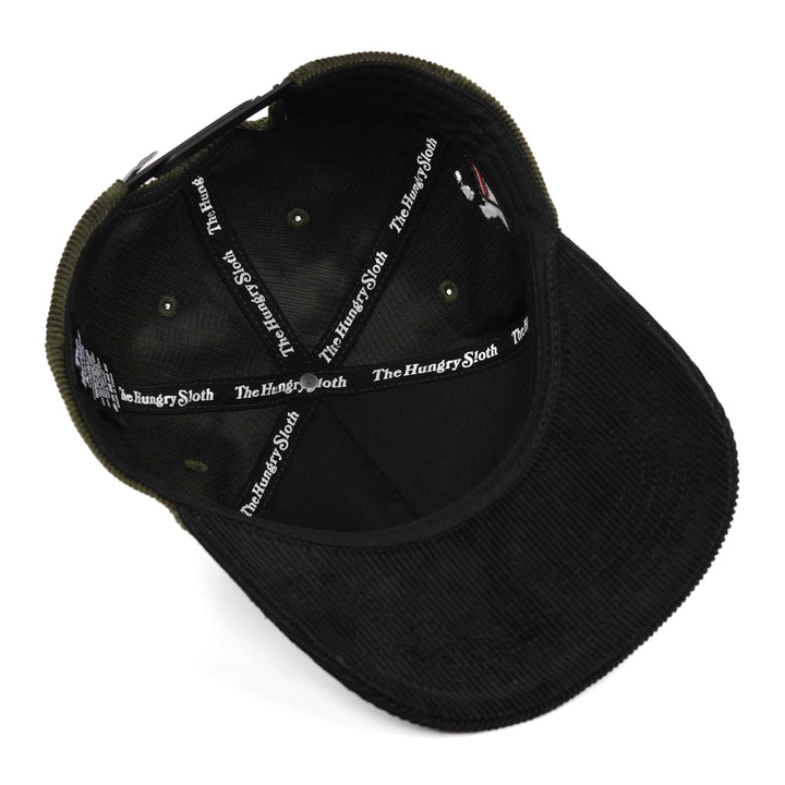 Black corduroy baseball cap shown from an overhead angle, highlighting the interior lining with &