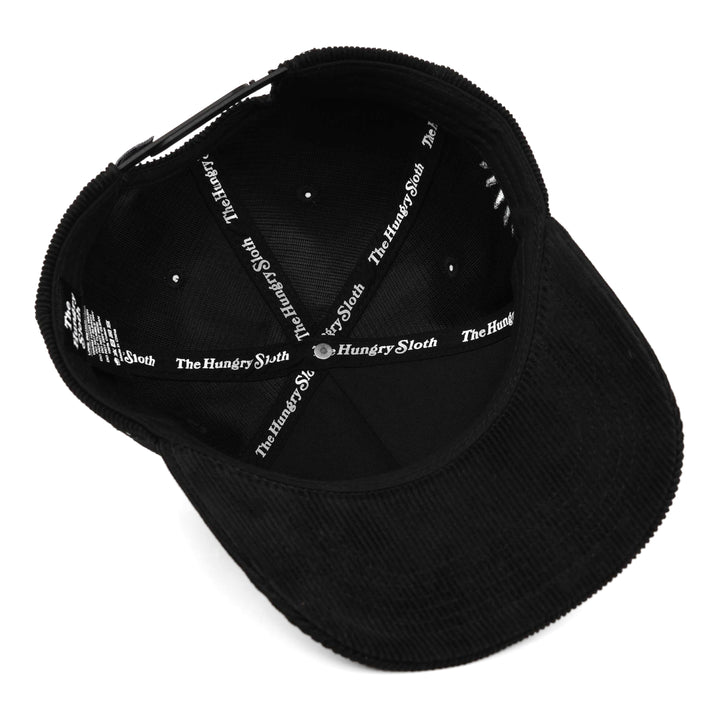 black corduroy snapback hat with the hungry sloth branding underneath