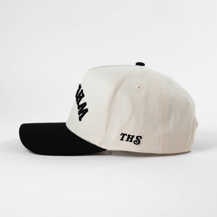 upside down whiskey snapback hat with THS branding on the side